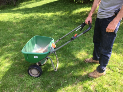 A person pushing a spreader