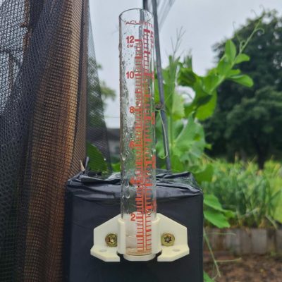 Rain gauge showing half an inch of rain on a cloudy day