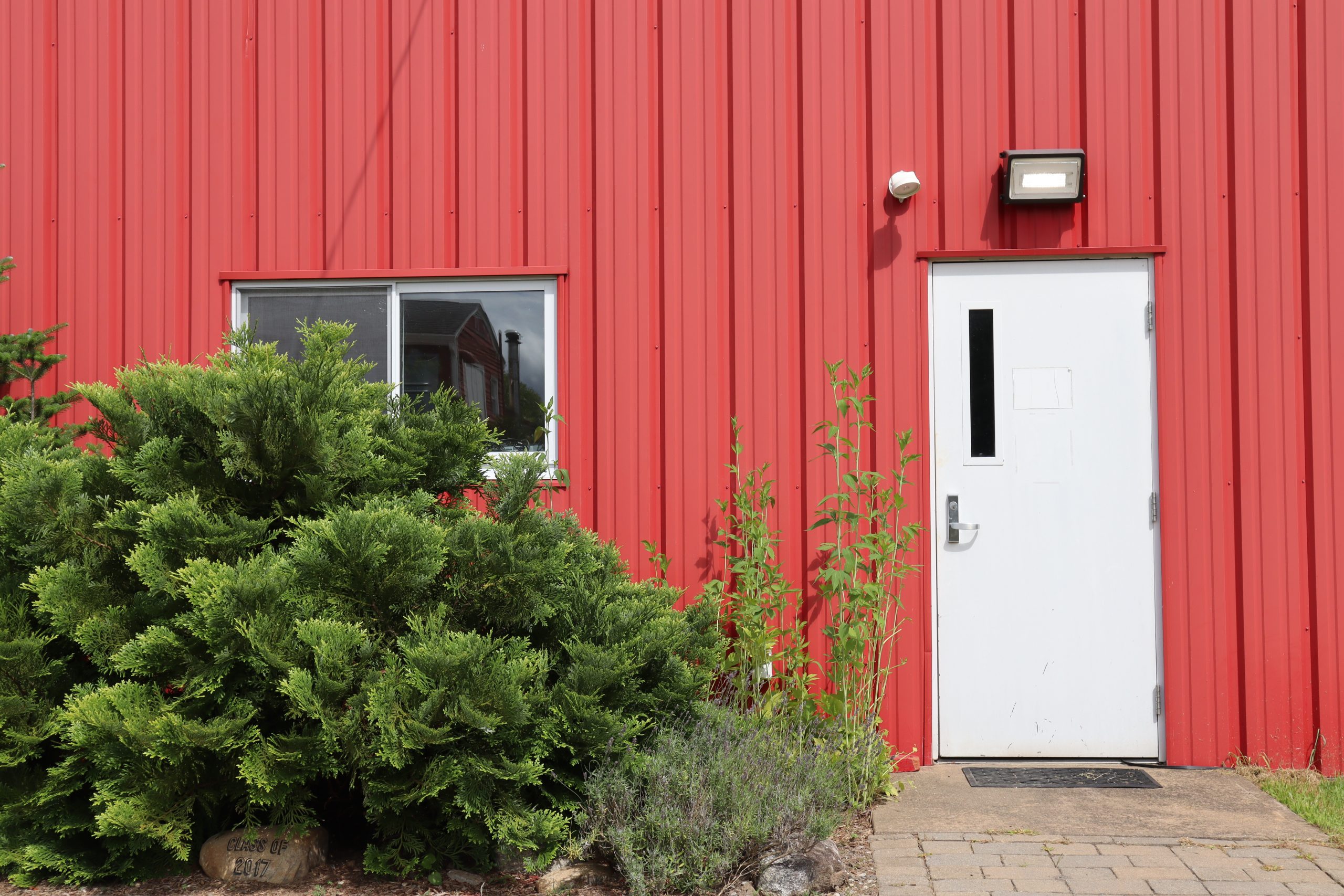 White door to a red barn